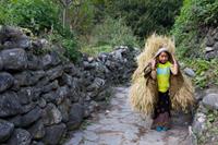 A little girl passes me on the trail to Nepal, I had to be quick with my camera to get this picture!